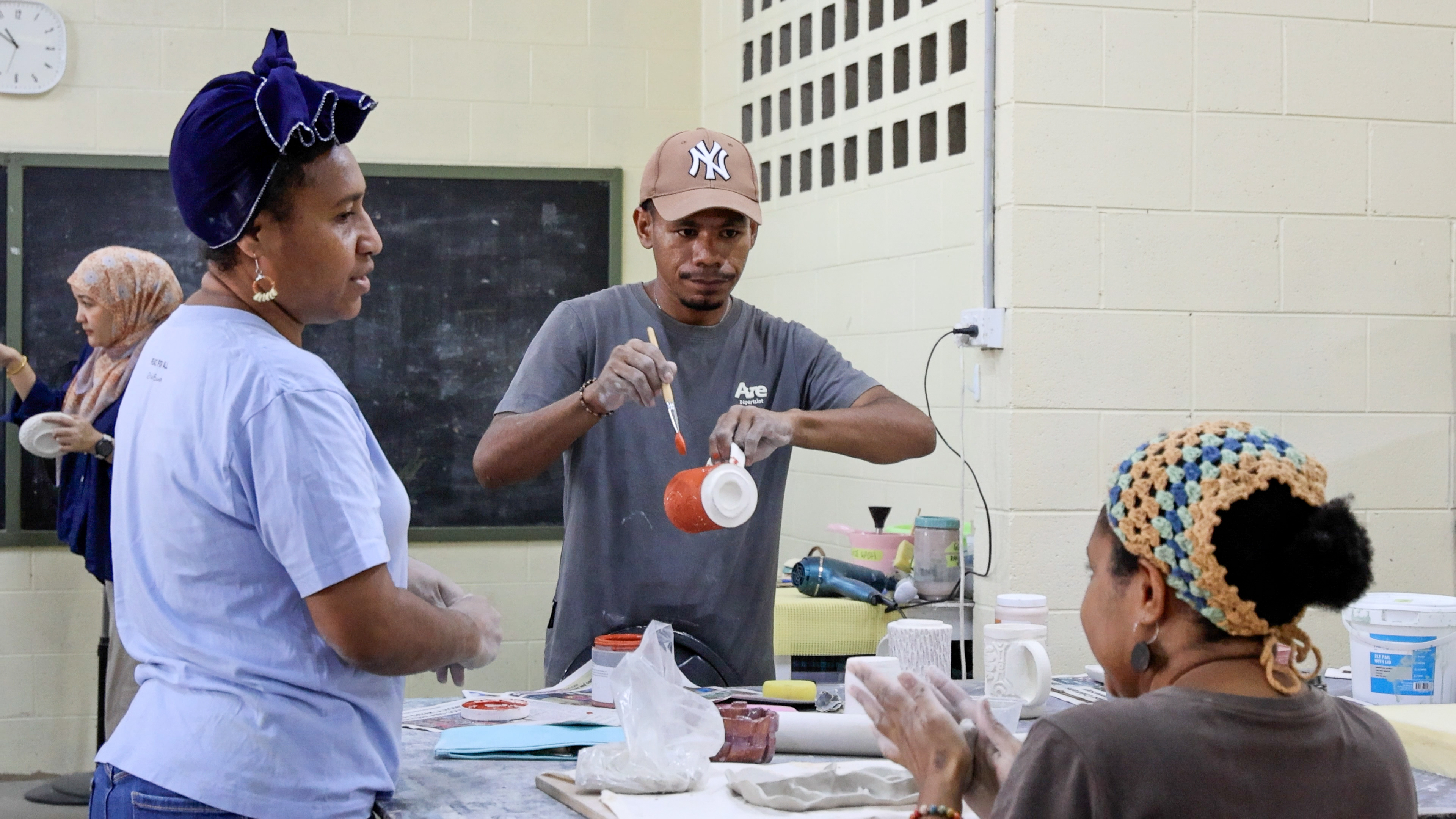 Melsen Kelebi and pottery class students