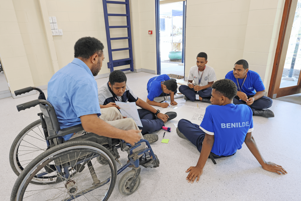 Samuel engaging with students during a session of the Youth Arts Program.
